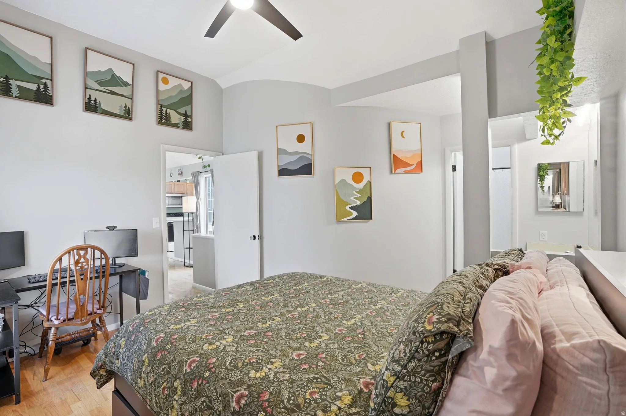 Bedroom featuring light wood finished floors, a ceiling fan, high end fridge, and a desk