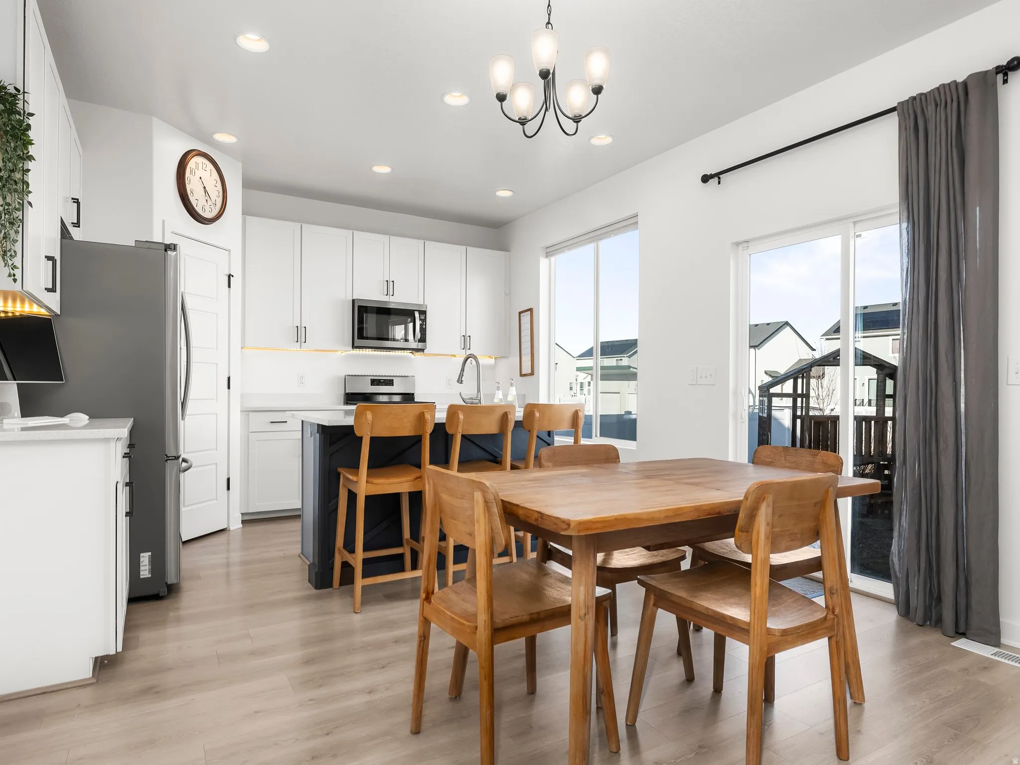 Dining area featuring light wood-type flooring and suspended lighting