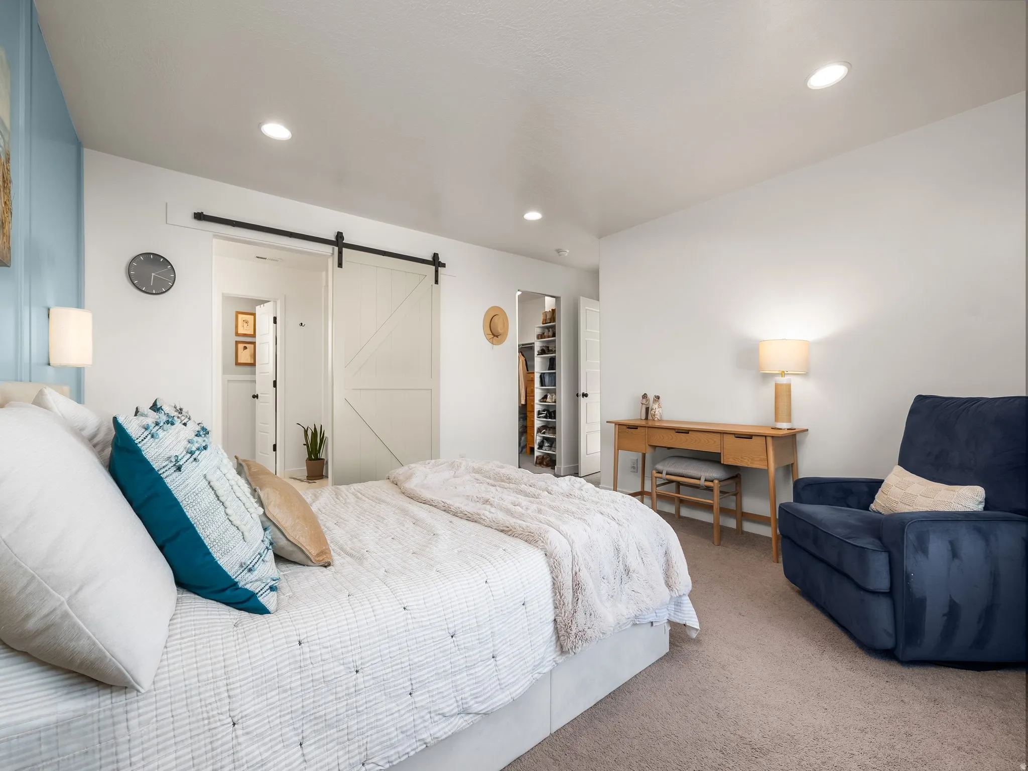 Bedroom featuring carpet, a spacious closet, a barn door, and recessed lighting
