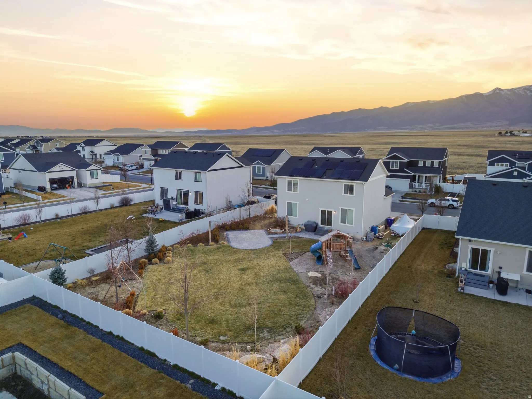 Aerial view of residential area featuring a mountainous background
