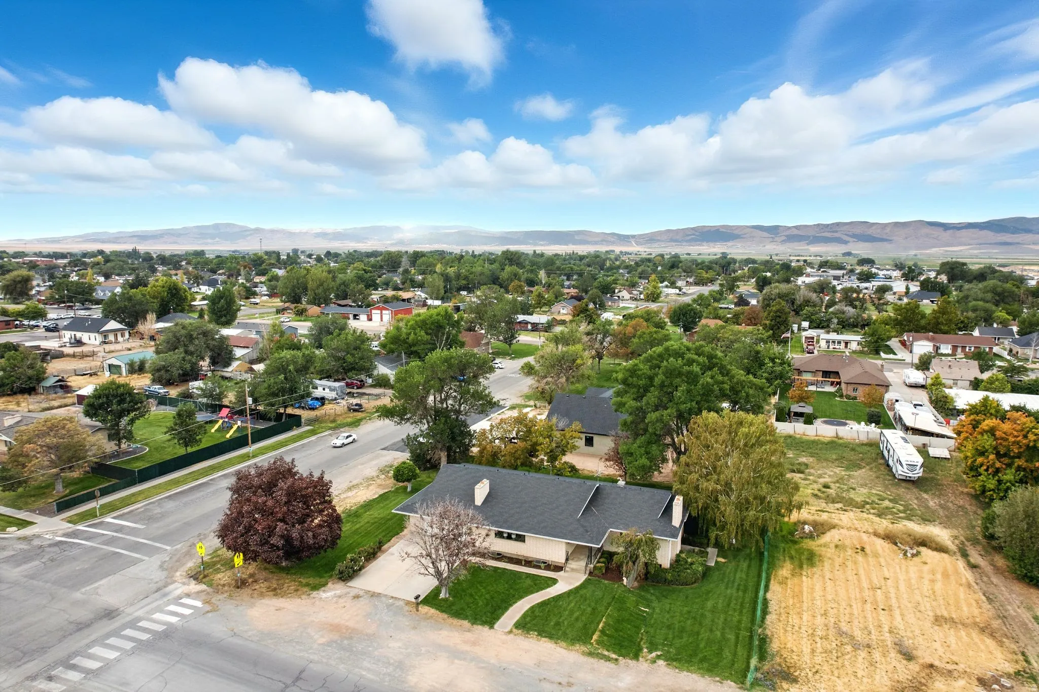 Aerial view of residential area featuring a mountainous background