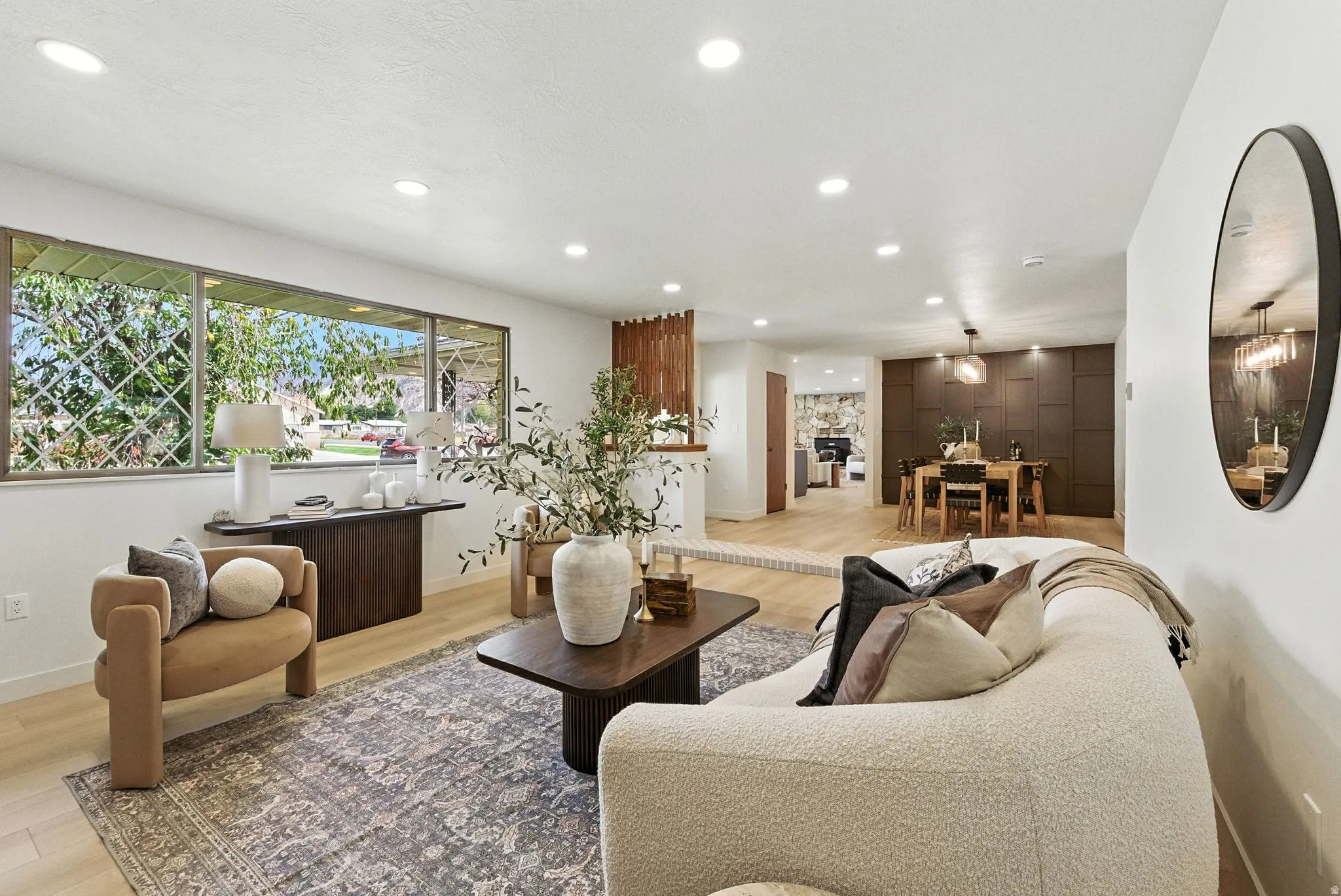 Living area with light wood finished floors and recessed lighting