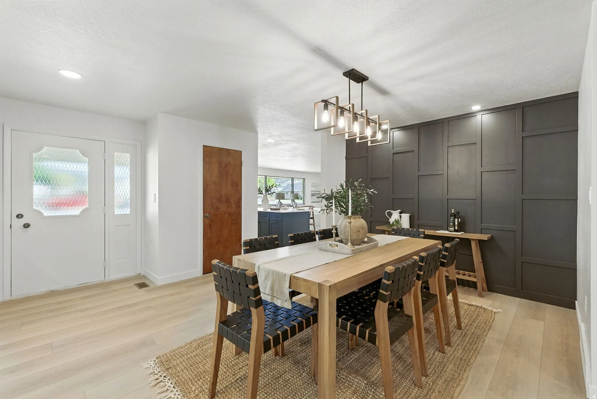 Dining space with light wood finished floors and recessed lighting