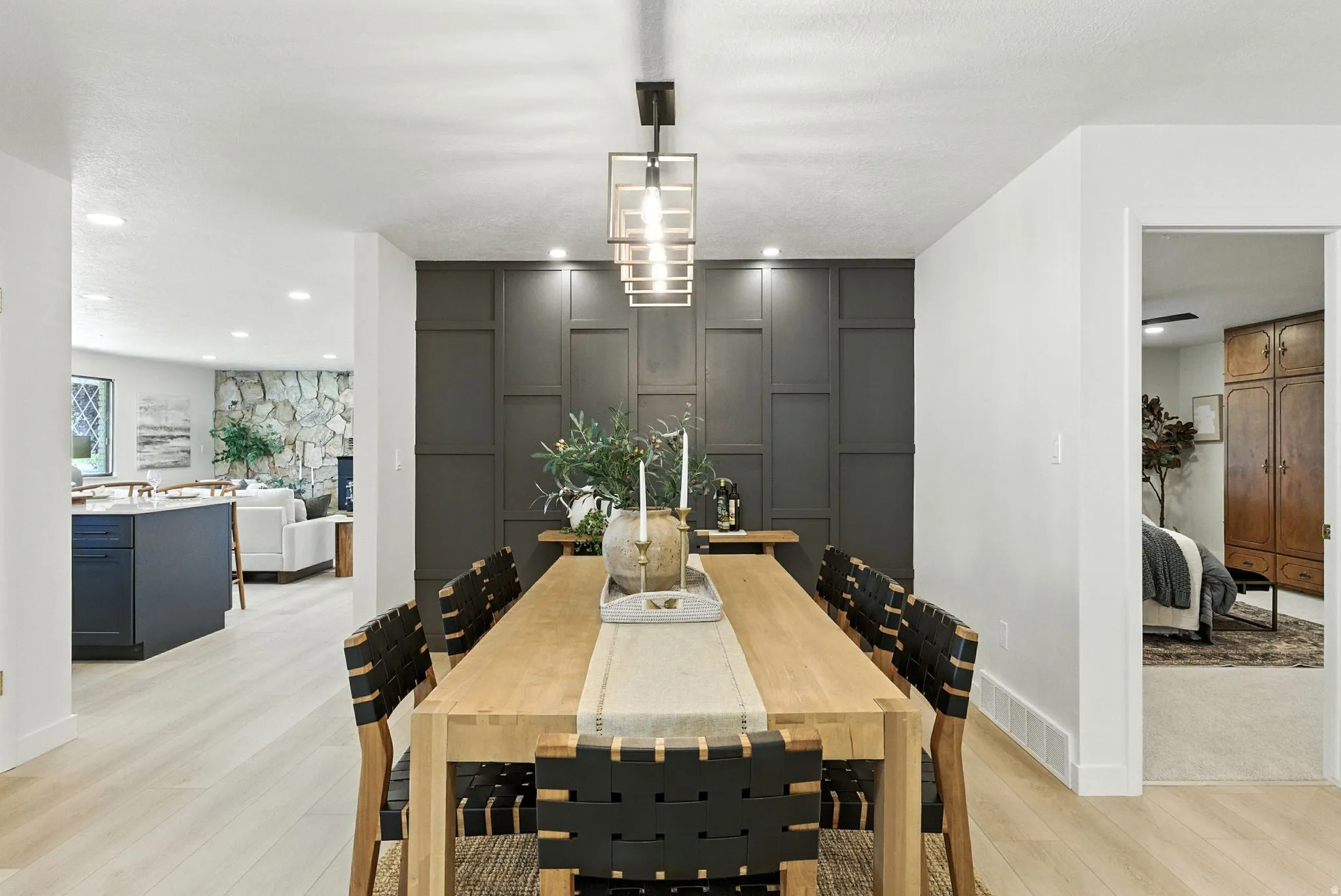 Dining room with light wood-style flooring and recessed lighting