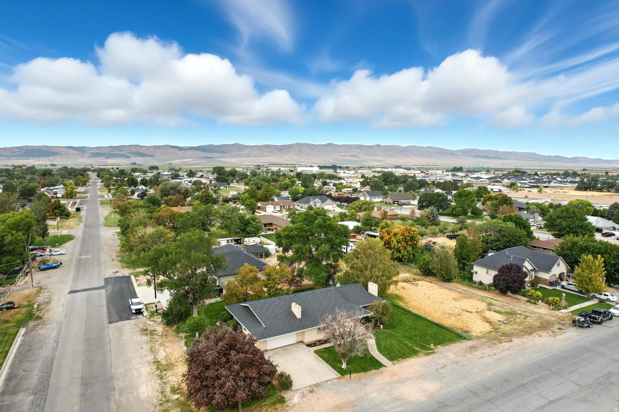 Aerial view of residential area featuring a mountainous background