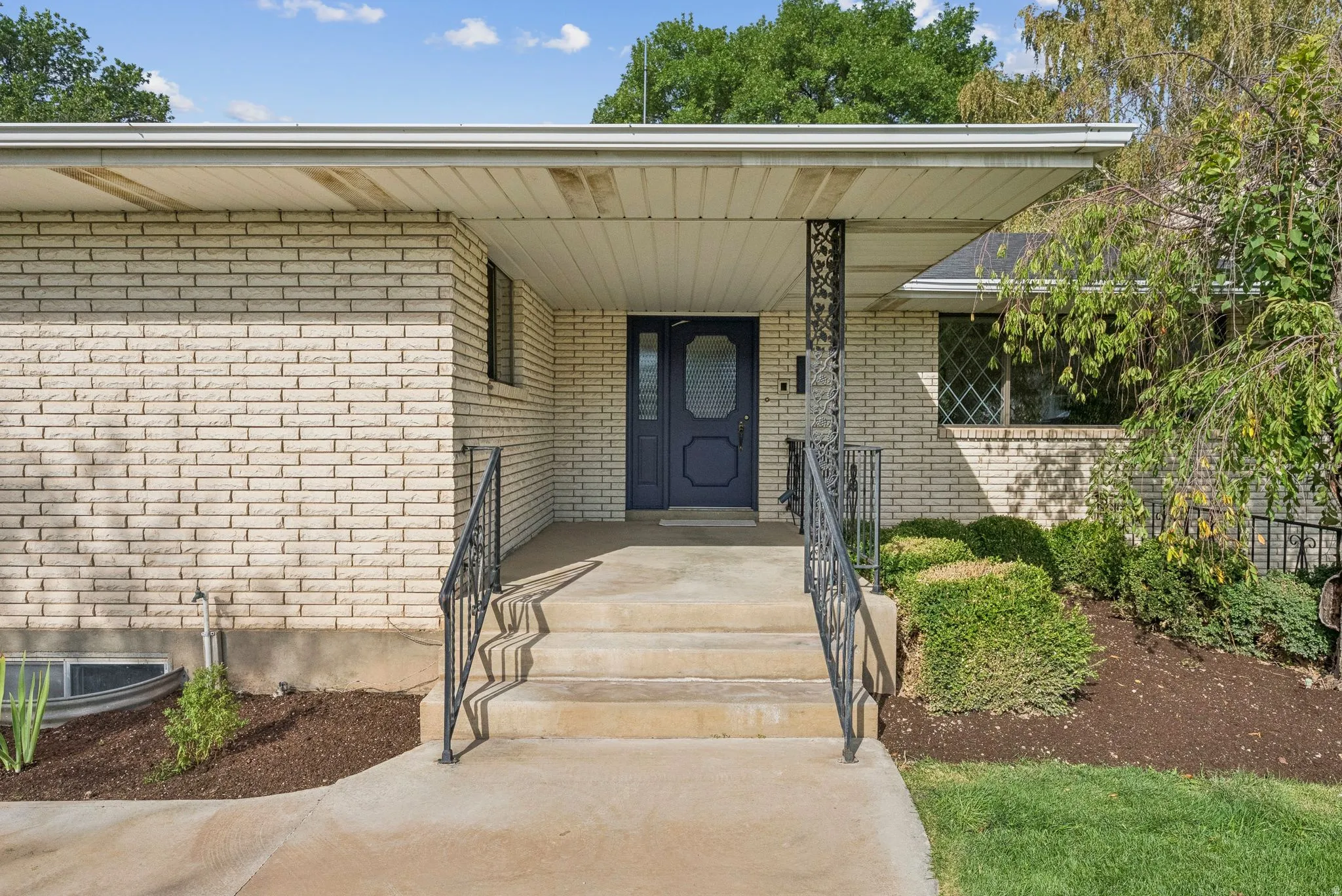 Doorway to property featuring brick siding