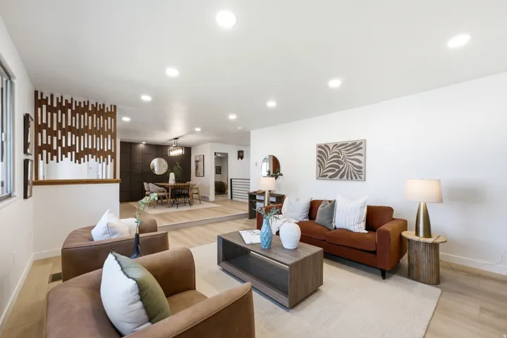 Bright living area featuring wood-finish flooring and recessed lighting