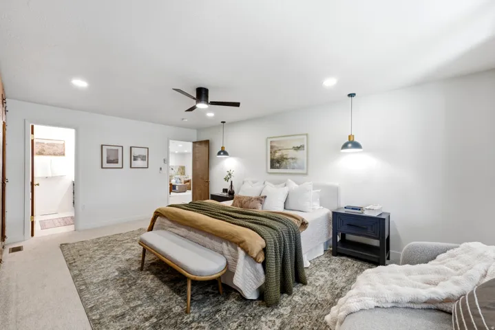 Spacious bedroom featuring recessed lighting, a ceiling fan, and carpeted flooring
