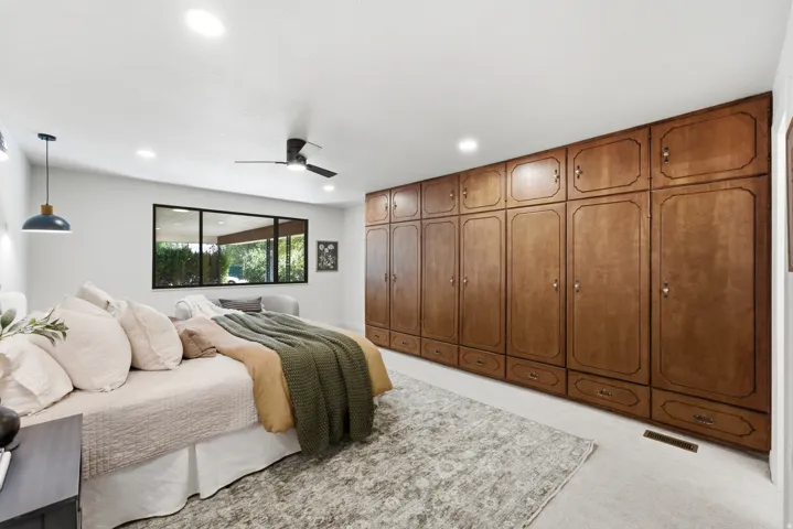 Built-in wood cabinetry with brass hardware provides extensive storage