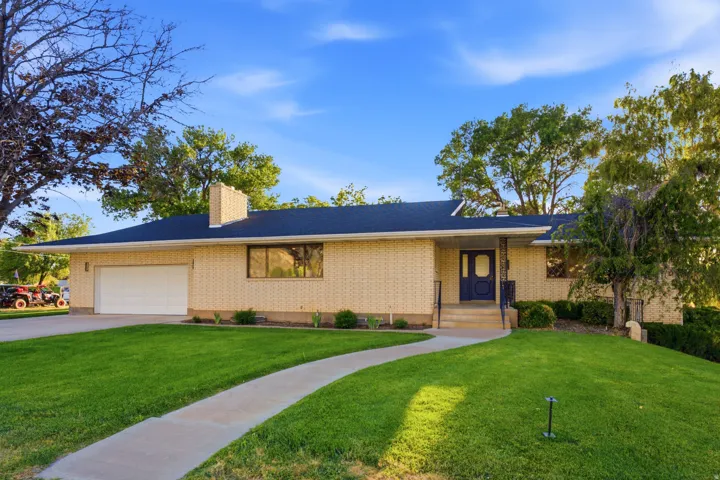 Ranch-style residence featuring a brick facade and a dark shingle roof
