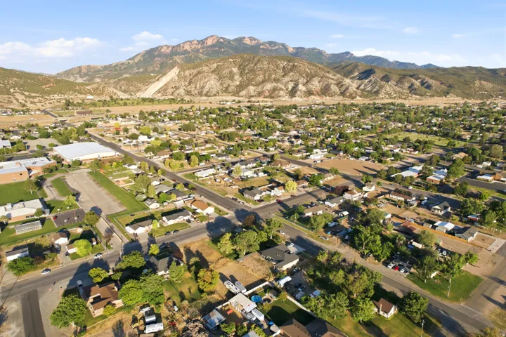Expansive aerial rendering a residential area with a mountainous backdrop