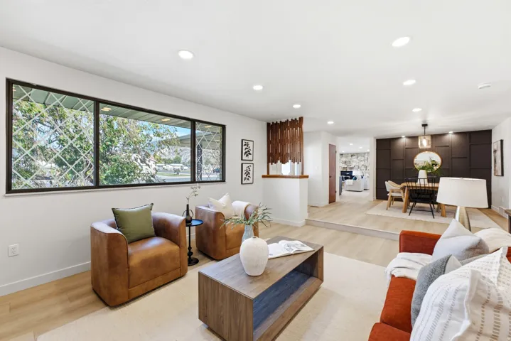 Open-concept living area featuring light wood-finish flooring and recessed lighting