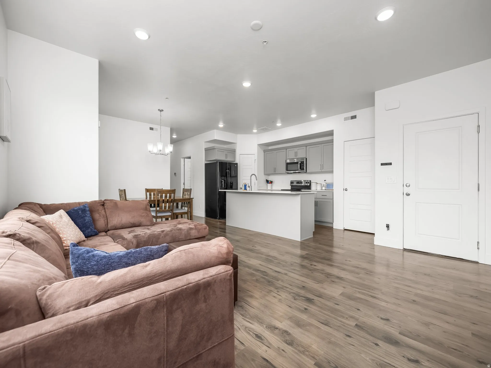 Living room featuring dark wood finished floors and hanging lights