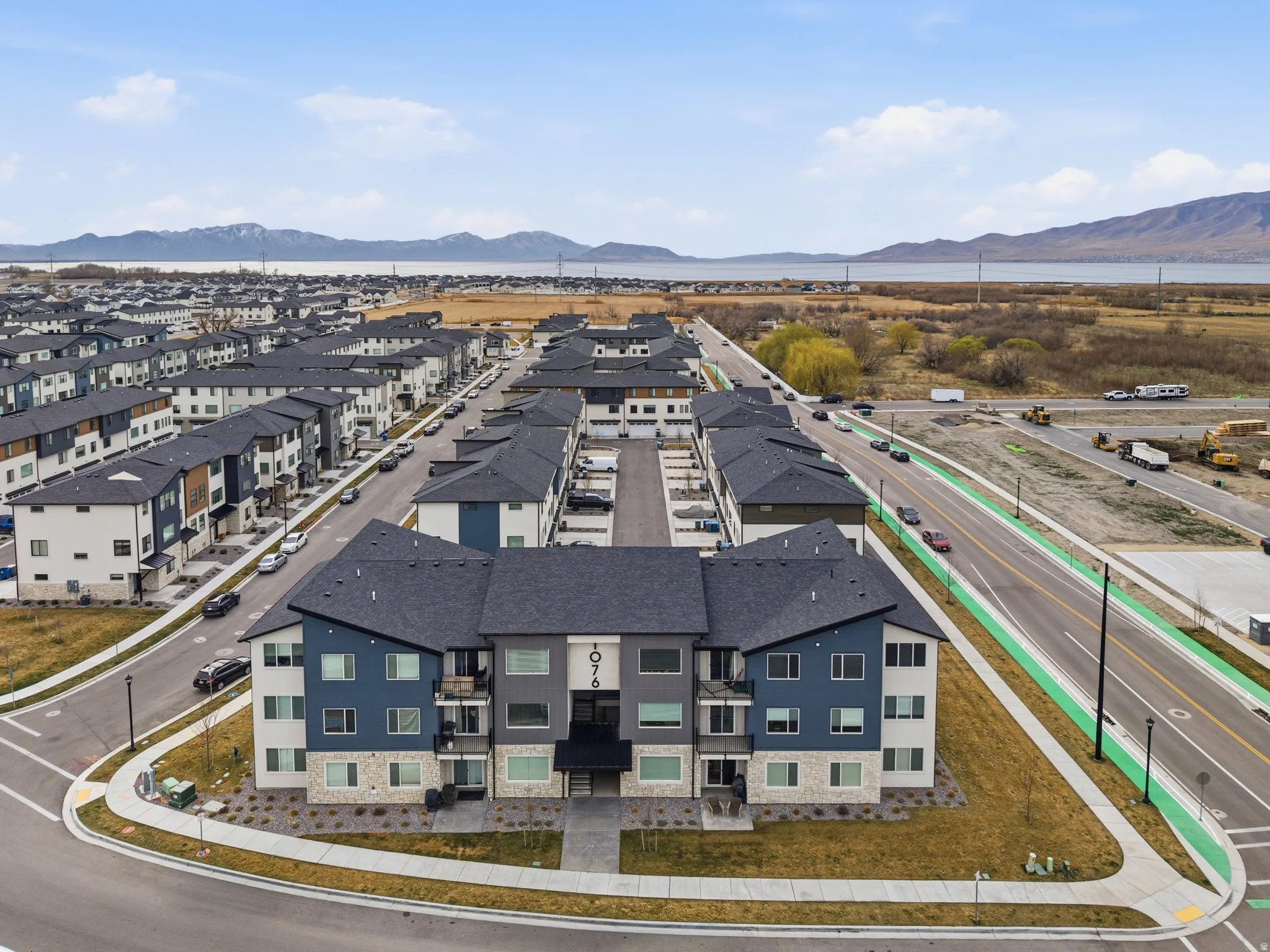 Aerial perspective of suburban area featuring mountains and lake