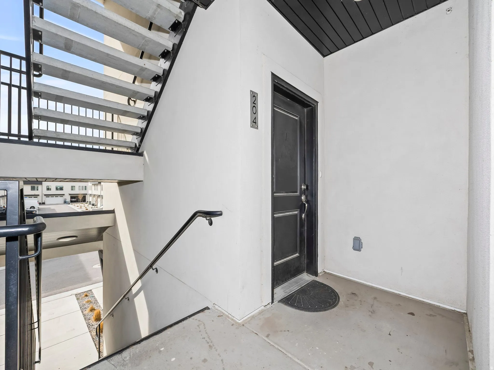 Property entrance featuring stucco siding