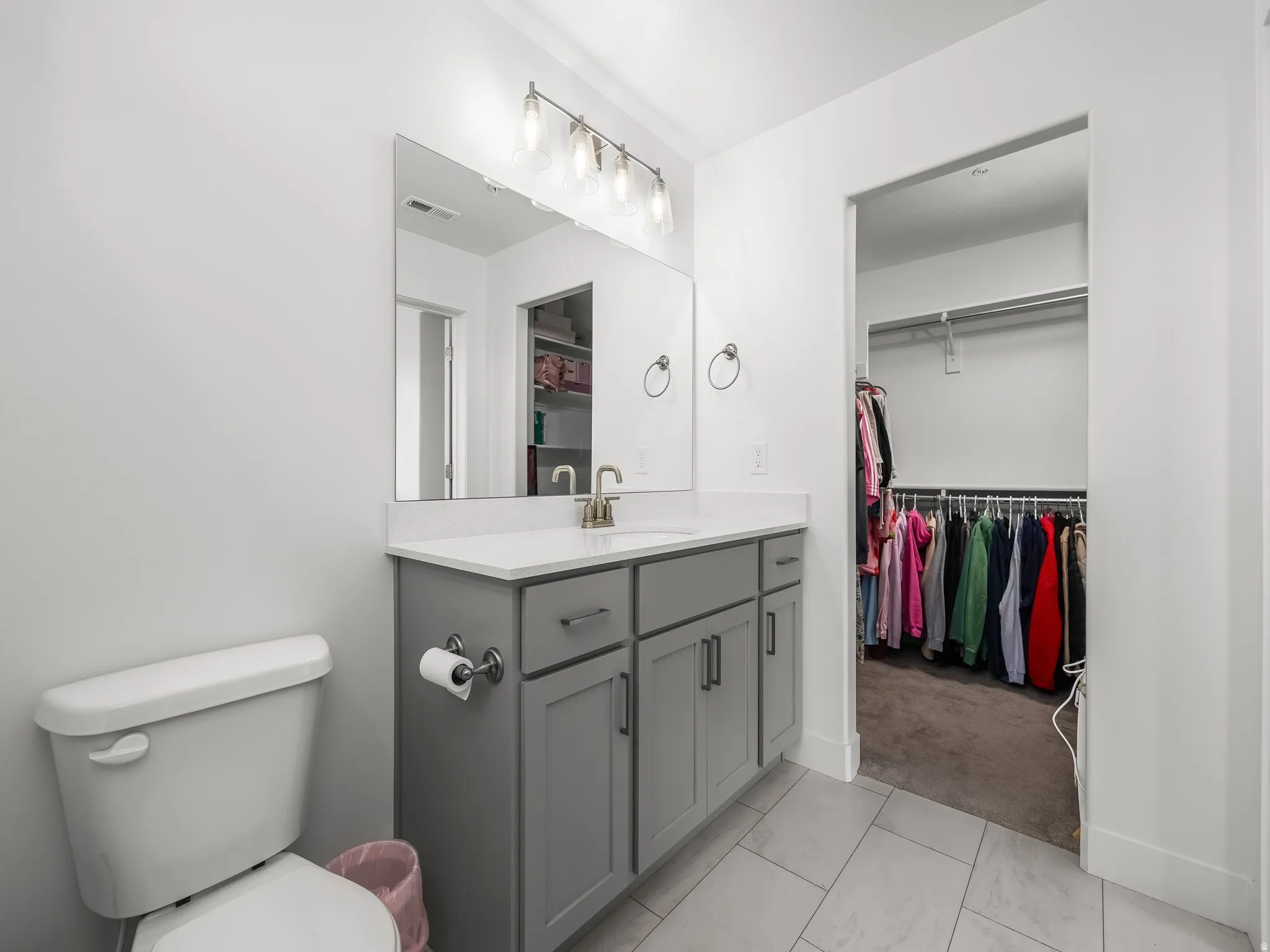 Bathroom featuring vanity and a spacious closet