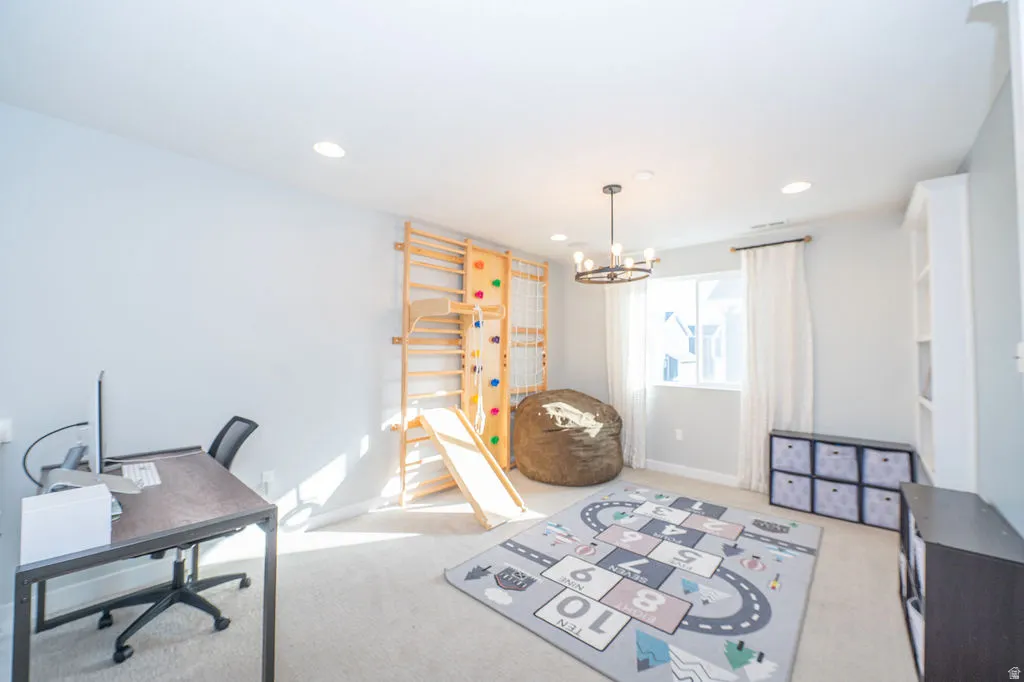 Home office featuring a chandelier and light colored carpet