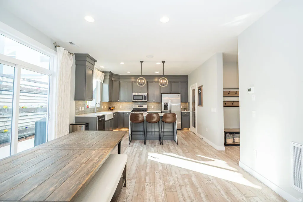 Dining room with recessed lighting and light wood-type flooring