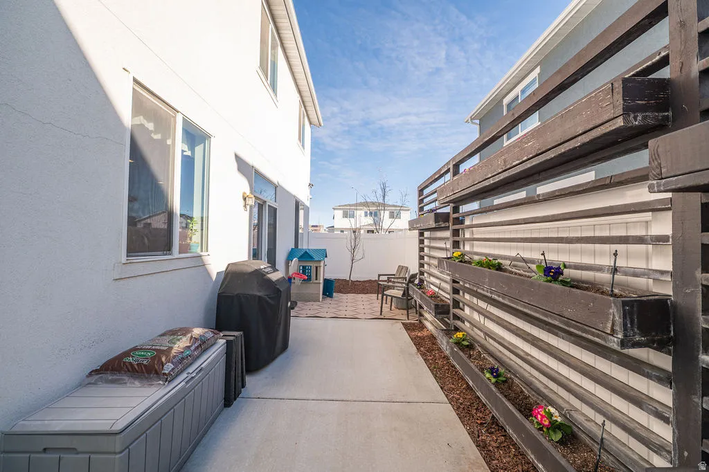Fenced backyard featuring a patio area and area for grilling
