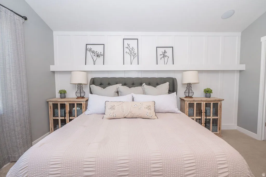 Bedroom with carpet floors and vaulted ceiling