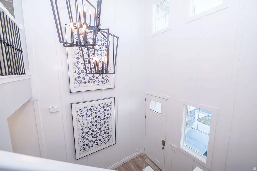 Entrance foyer featuring suspended lighting and wood finished floors