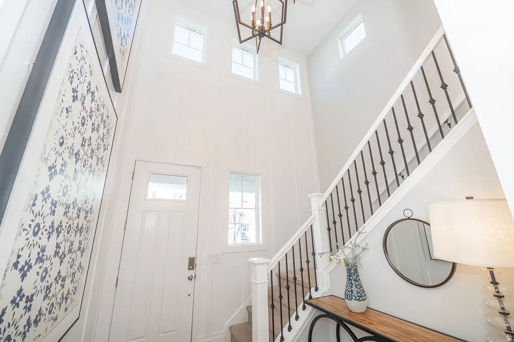 Entrance foyer with hanging lights and a high ceiling