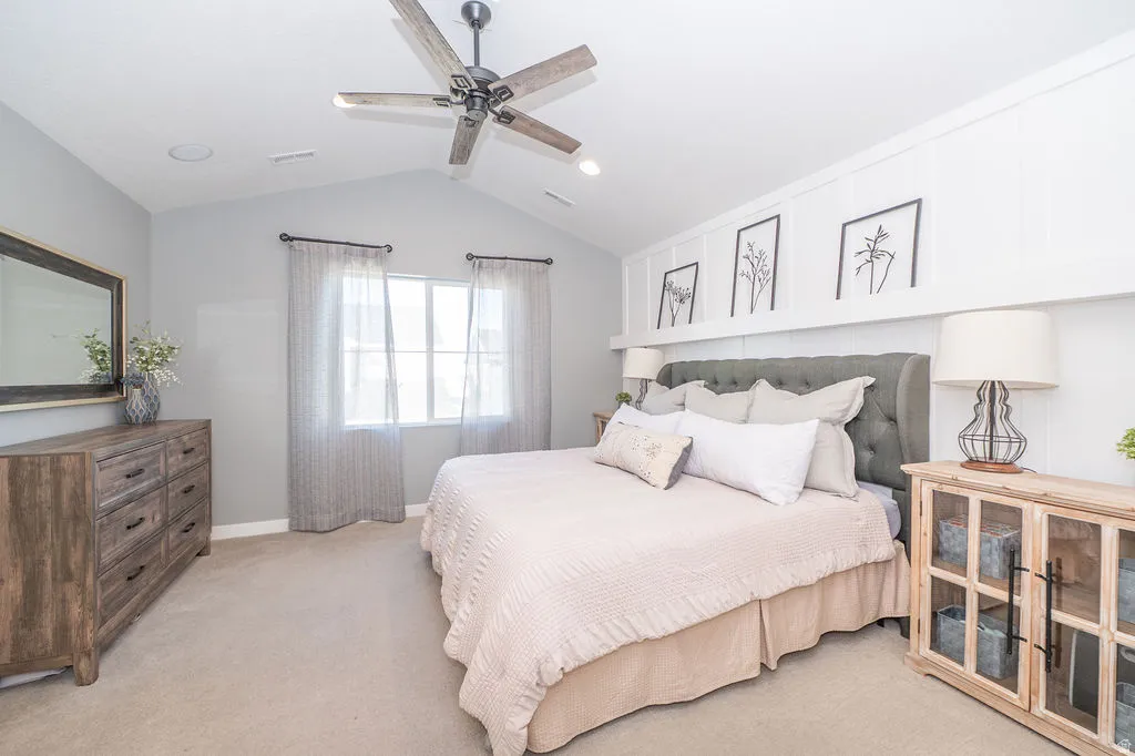 Bedroom with light colored carpet, ceiling fan, and recessed lighting