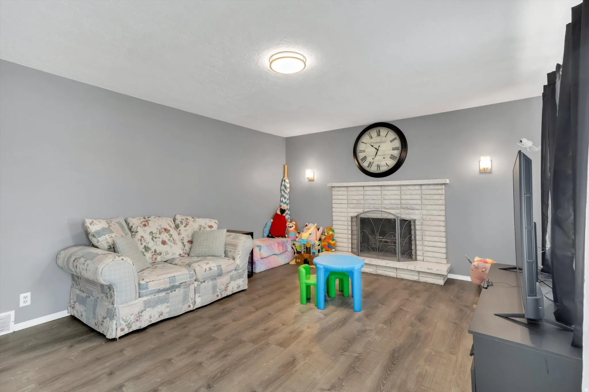 Living area with wood finished floors and a fireplace