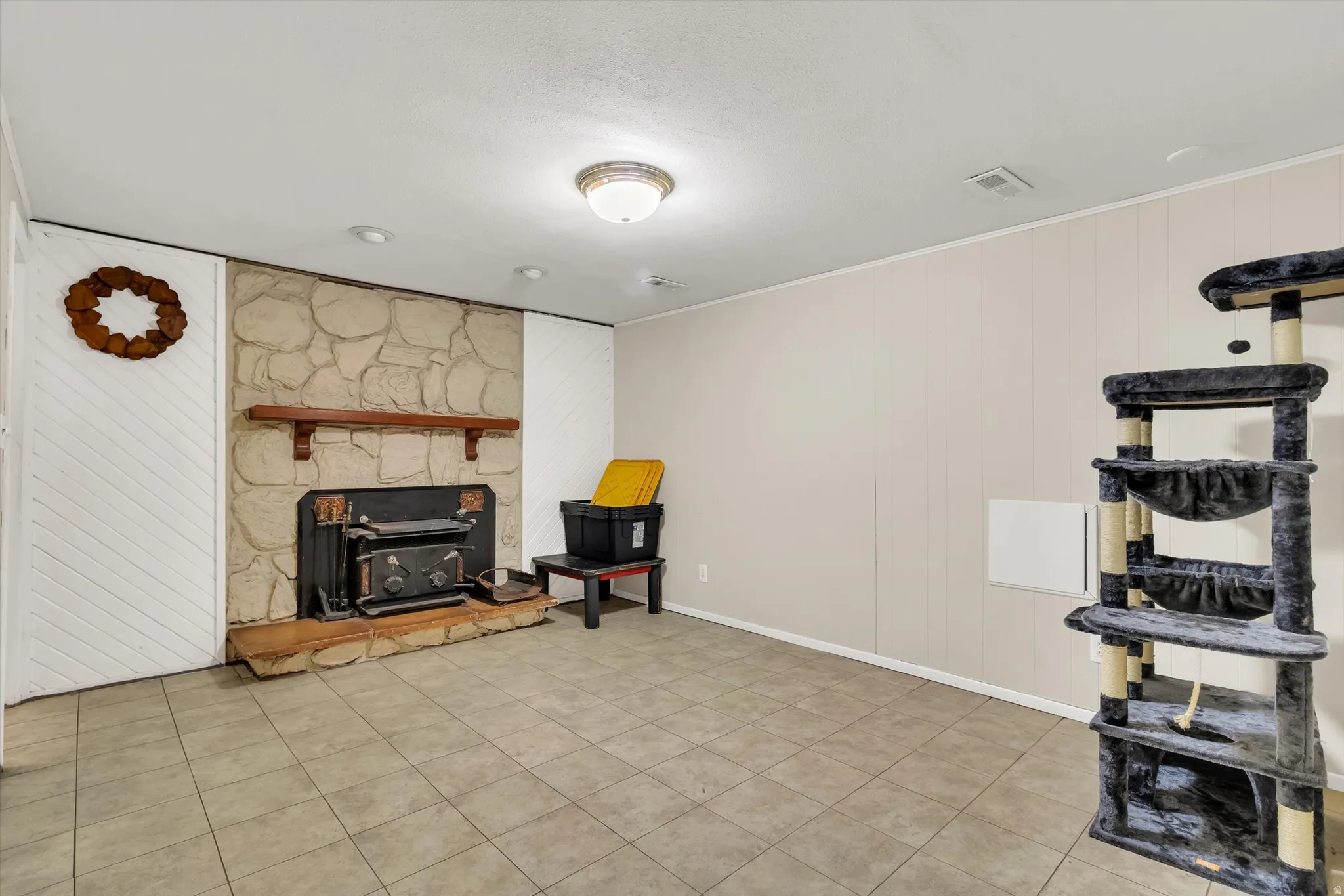 Sitting room with wood walls and light tile patterned floors