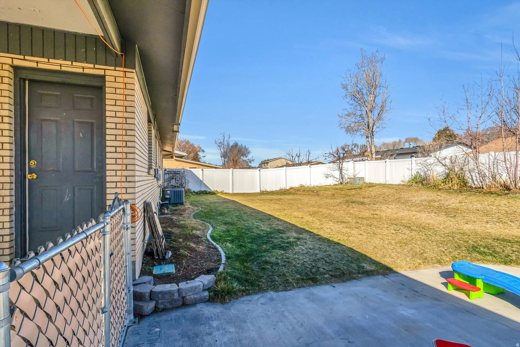 Fenced backyard featuring a patio