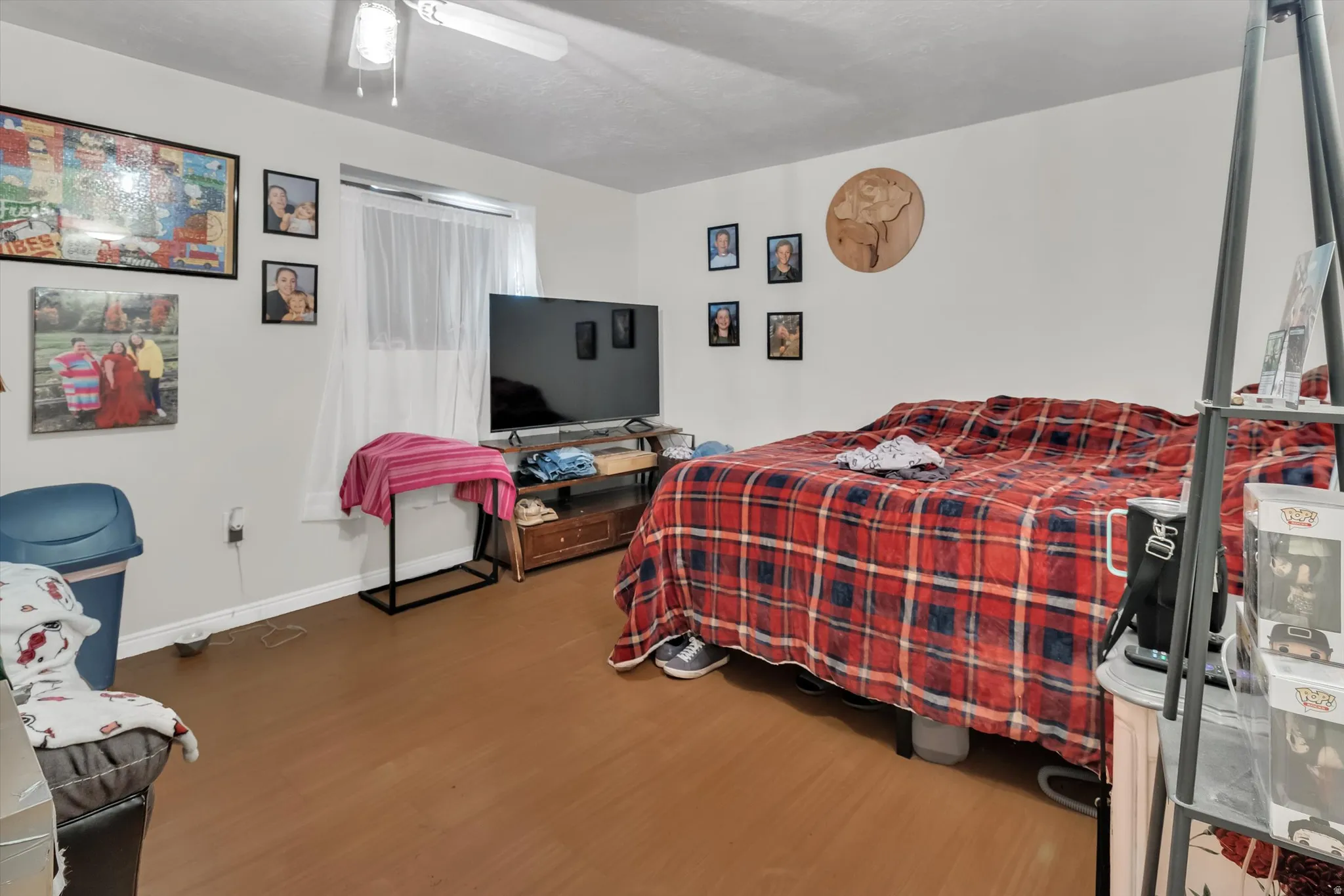 Bedroom with light wood finished floors and ceiling fan