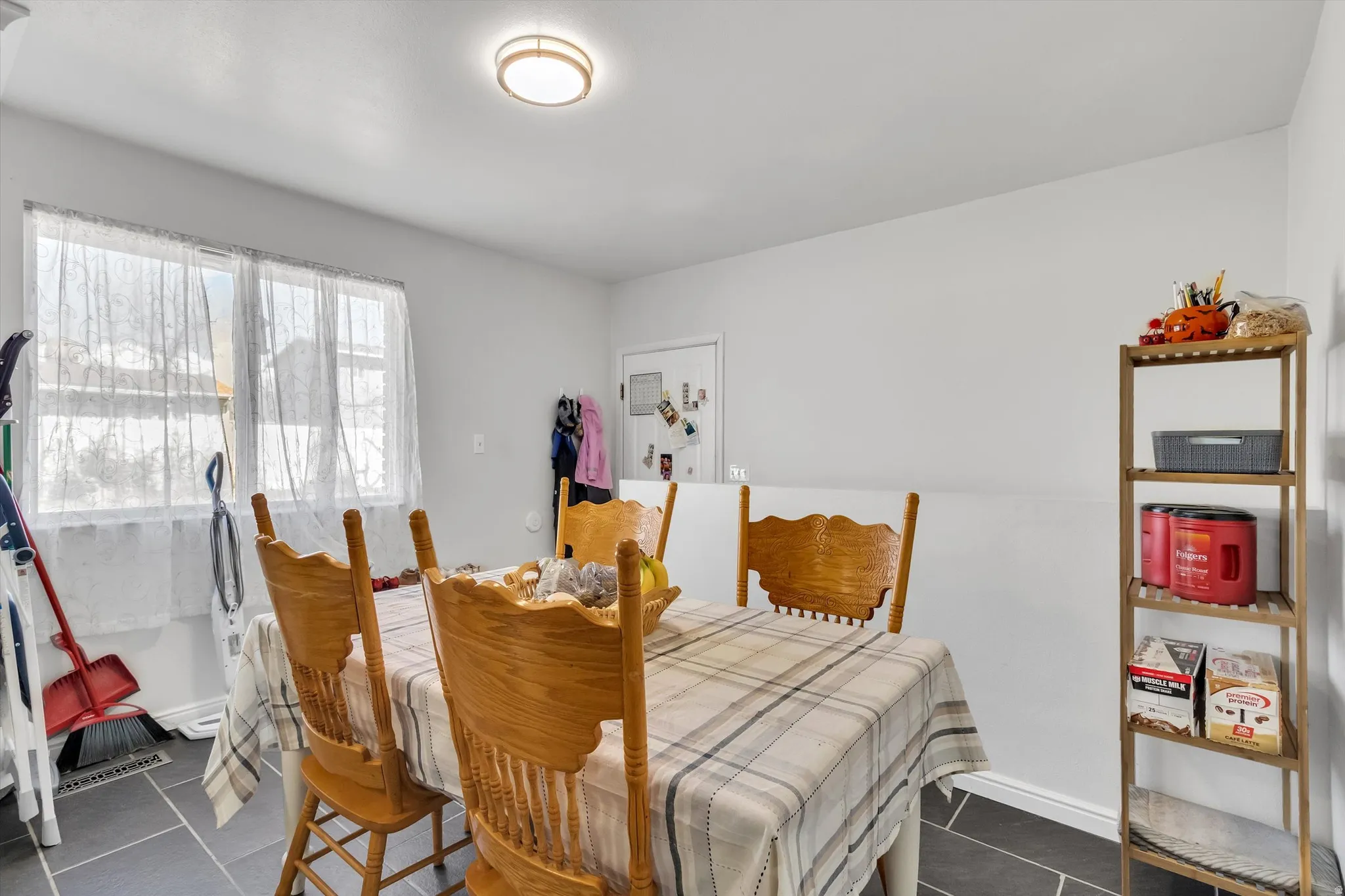 Dining area with baseboards and dark tile patterned flooring