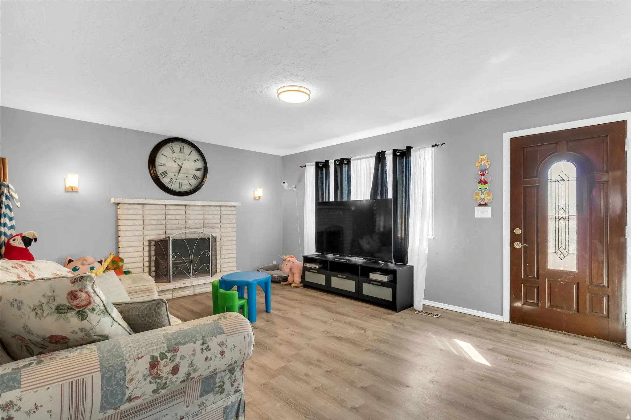 Living area with a fireplace and wood finished floors