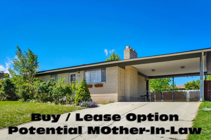 Single-story residence featuring light brick exterior, a covered carport, and a well-maintained front lawn