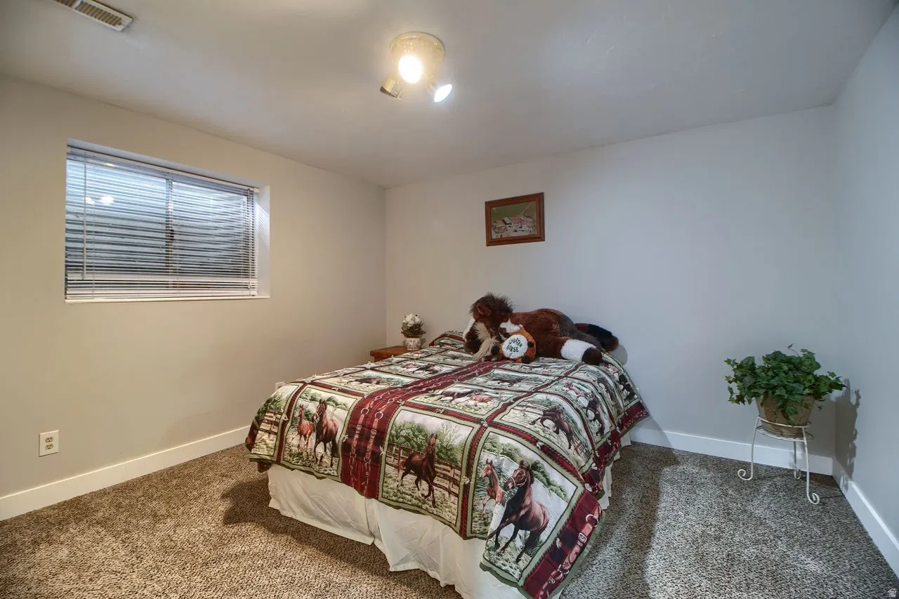 Bedroom featuring baseboards and carpet floors