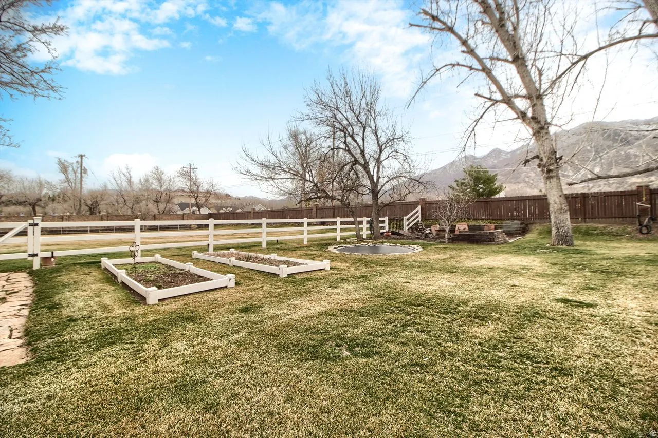 Fenced yard with a garden and a patio