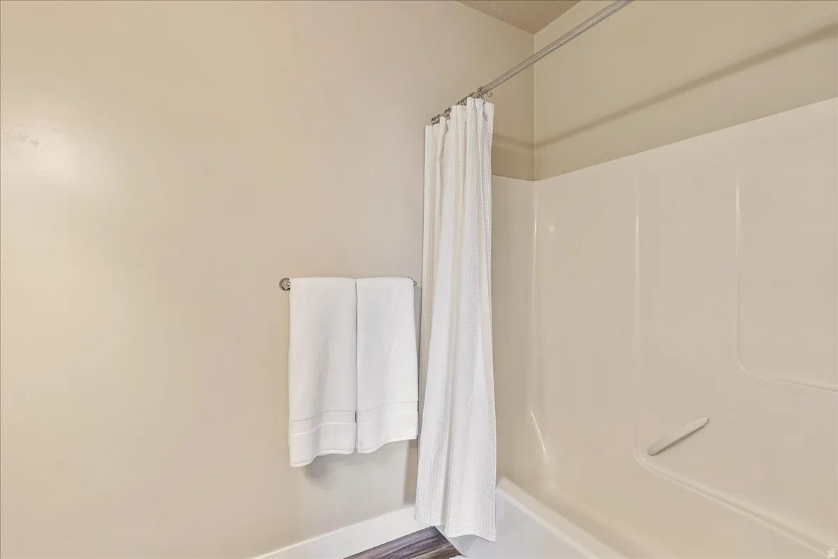 Bathroom featuring shower / bathtub combination with curtain
