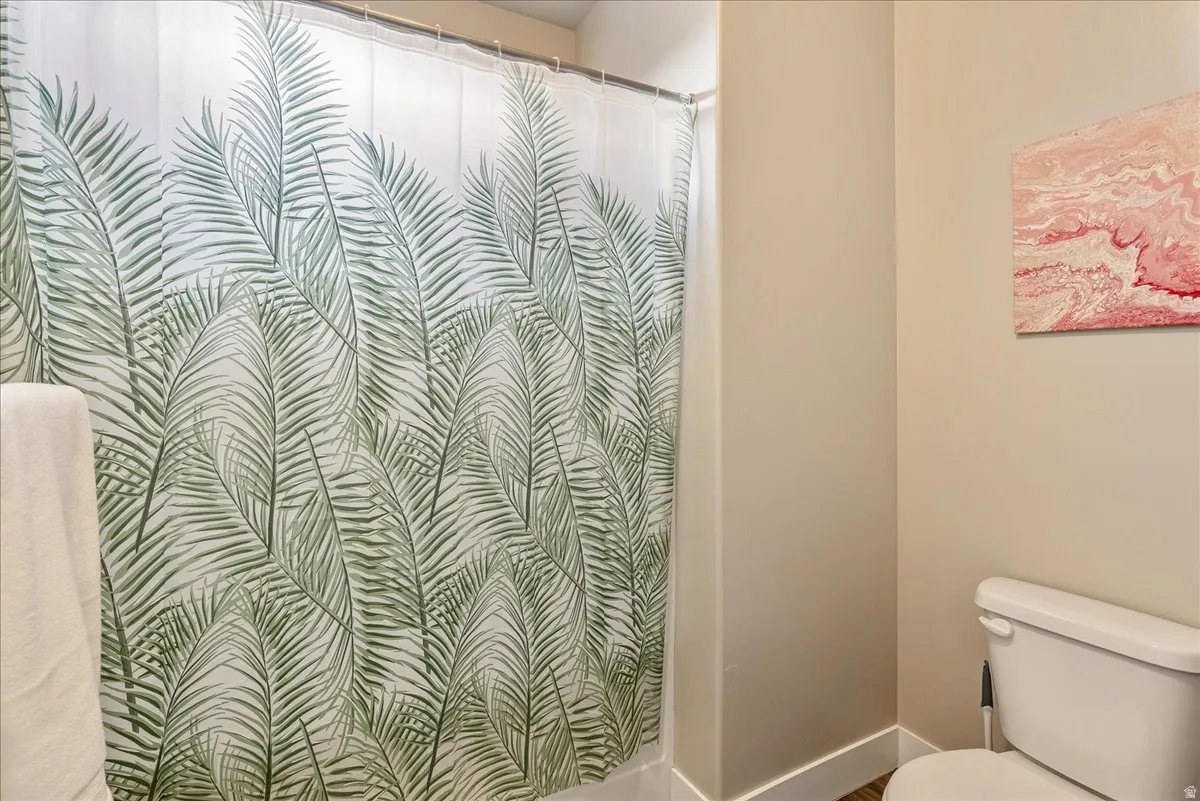 Bathroom featuring curtained shower