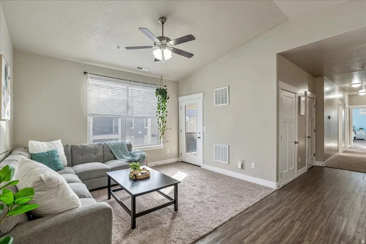 Living room with a ceiling fan and wood finished floors