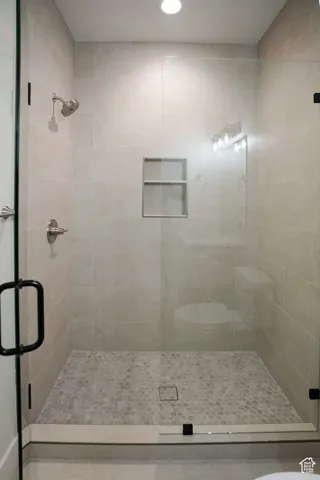 Bathroom with a shower stall and recessed lighting