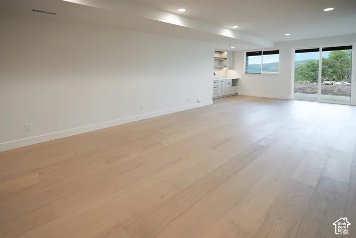 Unfurnished living room with light wood-style floors and recessed lighting