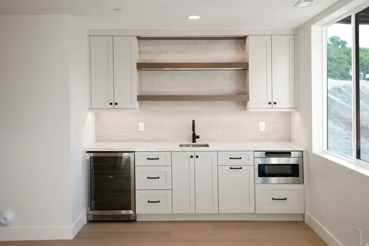 Bar featuring open shelves, beverage cooler, white cabinetry, tasteful backsplash, and recessed lighting