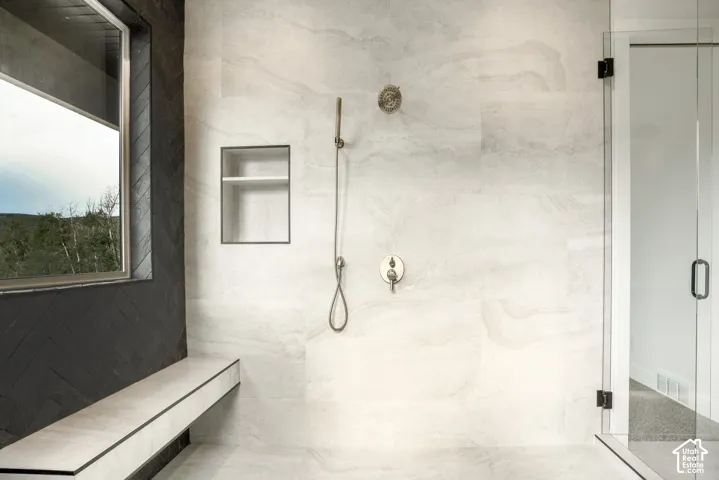 Bathroom with a marble finish shower