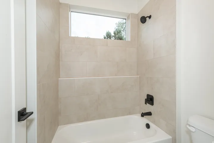 Full bath with toilet and bathtub / shower combination