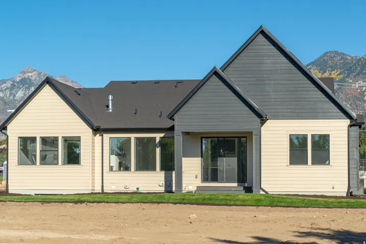 Rear view of property with a mountain view and a patio area