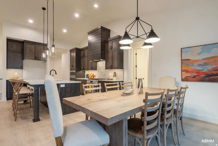 Dining area with recessed lighting and light wood-style floors