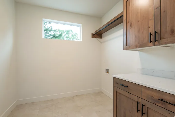 Laundry area featuring cabinet space and hookup for a washing machine