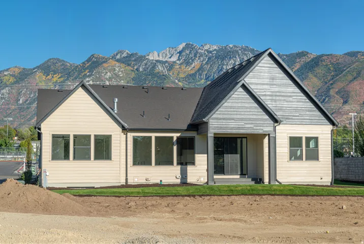 Rear view of property with a mountain view and a patio area