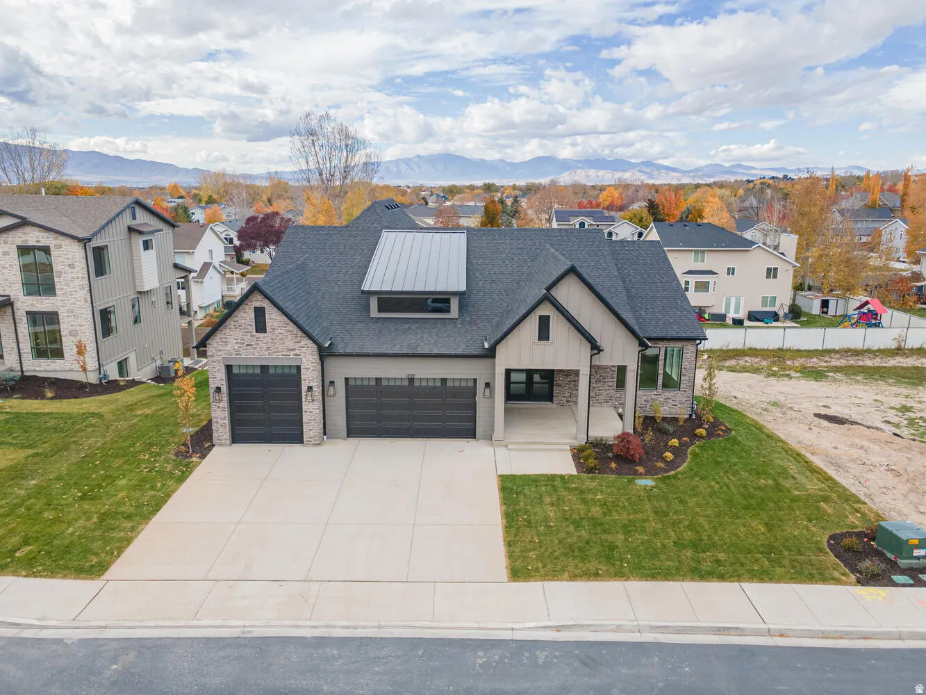 Modern farmhouse style home featuring a porch, a residential view, roof with shingles, and an attached garage