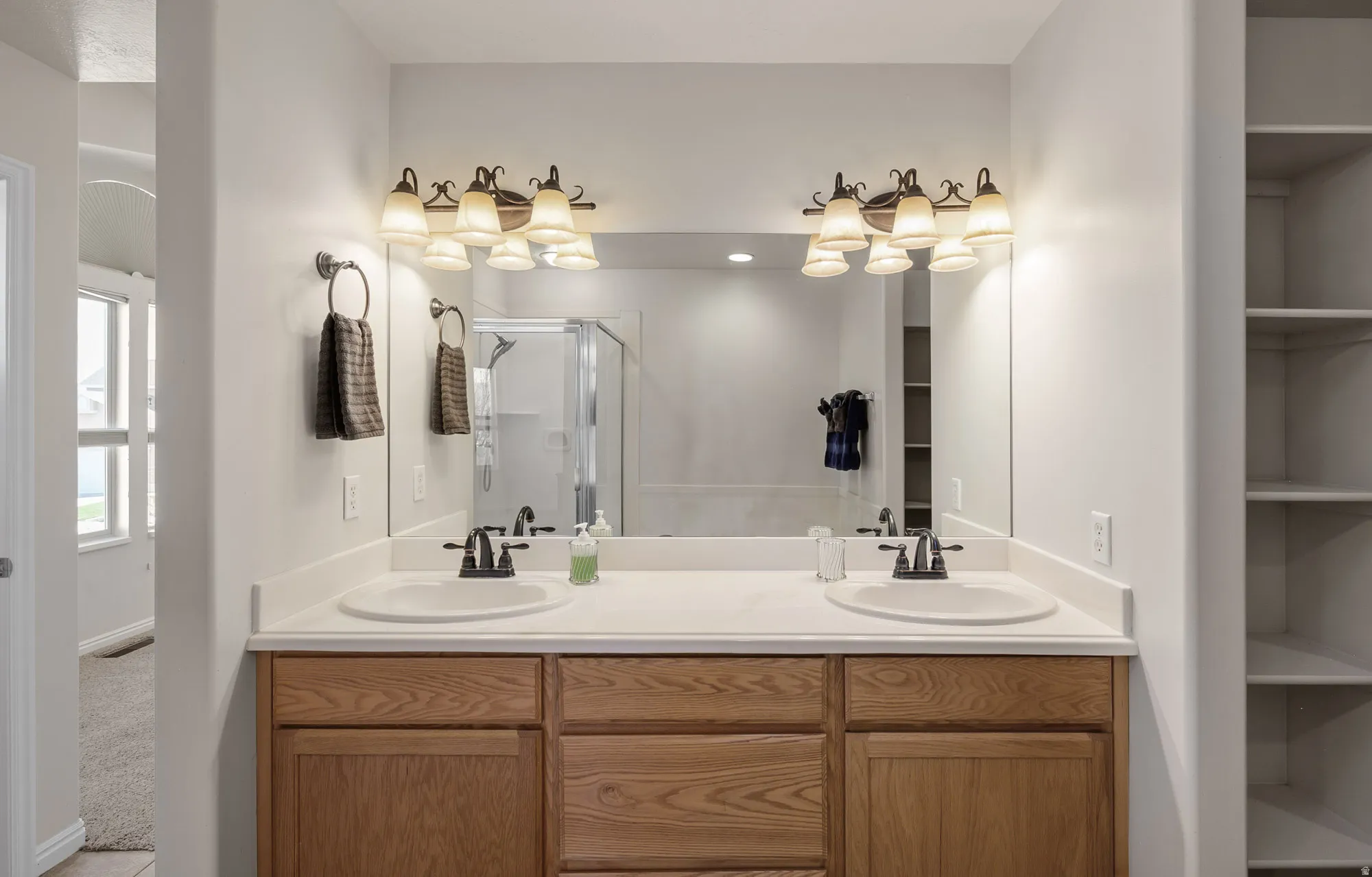 Master Bathroom with double vanity and a stall shower